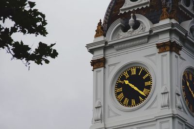 High section of clock tower against clear sky