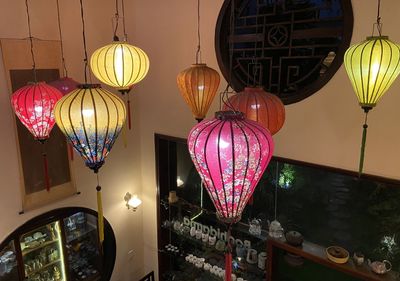 Low angle view of illuminated lanterns hanging on ceiling