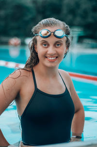 Portrait of a smiling young woman swimming in pool