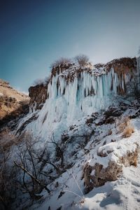 Scenic view of snowcapped mountains against clear sky