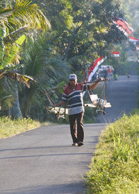 Rear view of people walking on road