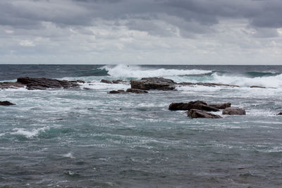 Scenic view of sea against cloudy sky