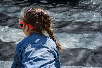 Rear view of girl against sea