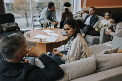 Business colleagues discussing strategy during meeting in office