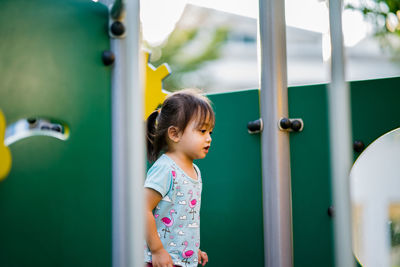 Cute girl looking at playground