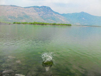 Scenic view of lake and mountains against sky