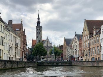 River amidst buildings against sky in city