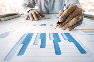 Midsection of man working on table