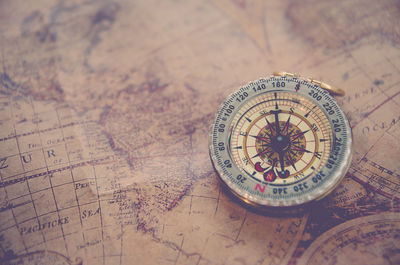 Close-up of navigational compass on map