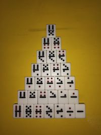 High angle view of number on table against yellow background