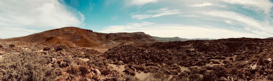 Scenic view of arid landscape against sky