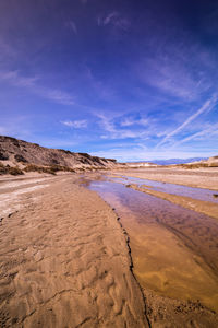 Sand dunes in desert against sky