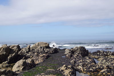 Rocks on beach against sky