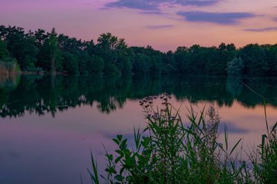 Scenic view of lake against sky at sunset