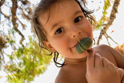 Close-up portrait of a girl holding fruit