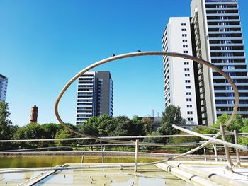 Modern buildings against clear blue sky