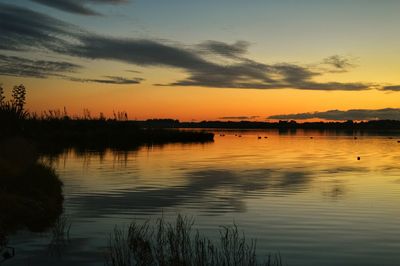 Scenic view of lake at sunset