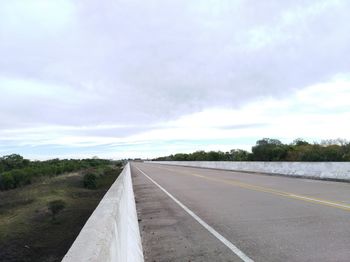 Empty road along countryside landscape