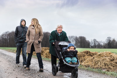 Family on road against sky