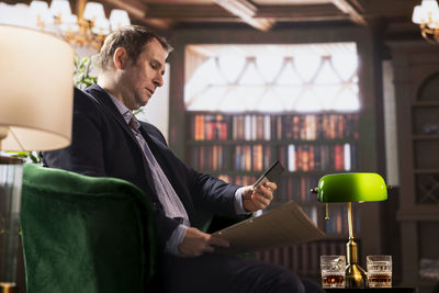 Side view of man using digital tablet