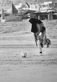 Man playing with ball on beach