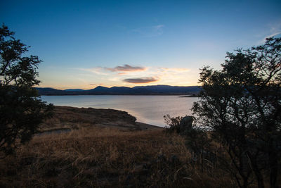 Scenic view of lake against sky during sunset