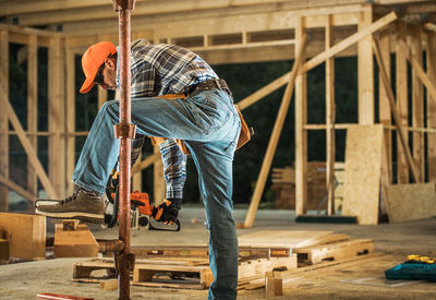 Side view of carpenter working at construction site