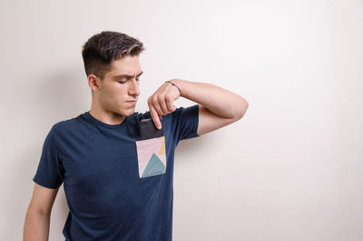 Young man looking away against white background