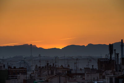 High angle view of townscape against orange sky