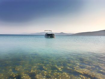 Boat sailing in sea against sky