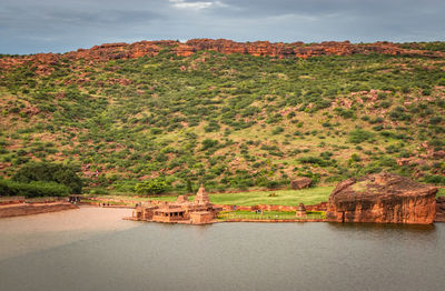 Temple on the shores of lake with mountain in background