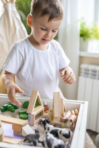 High angle view of boy playing with toy blocks