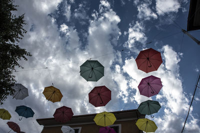 Low angle view of lanterns hanging against sky