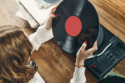 Woman playing music from vinyl record. analog record. retro and vintage style. analog sound. music