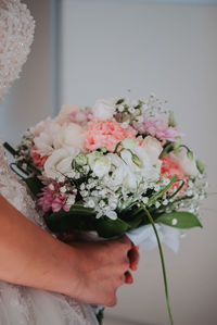 Close-up of hand holding flower bouquet