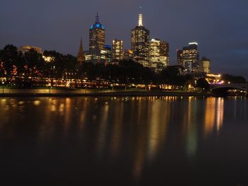 Illuminated city at waterfront