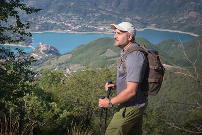 Man looking away while standing on mountain