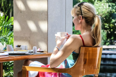 Close-up of young woman sitting at table