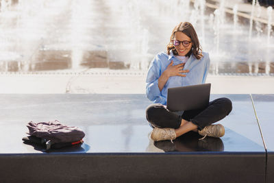 Portrait of young woman using mobile phone