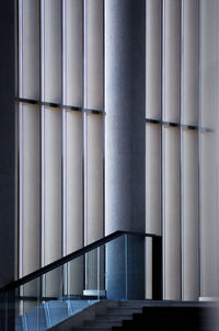 Staircase by window blinds in modern building