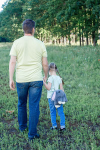 Rear view of man and woman standing on land