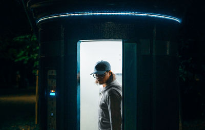 Man in public toilet at night