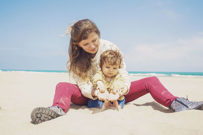 Happy woman on beach against sky