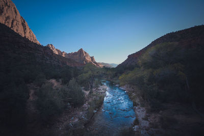 Scenic view of mountains against clear blue sky