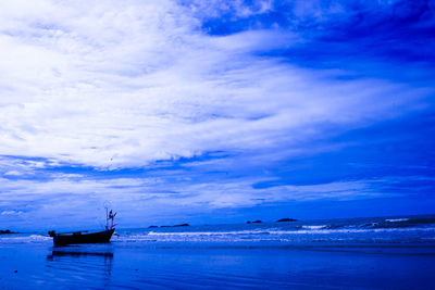 Boat moored on sea against sky