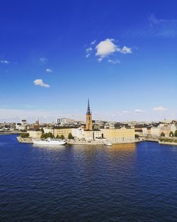 River amidst buildings against blue sky