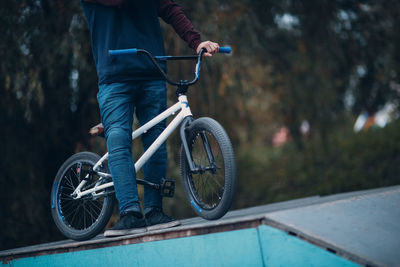 Man with bicycle at park