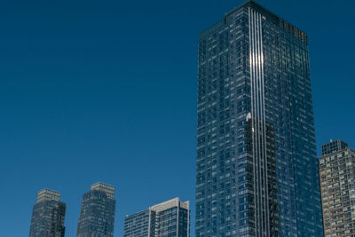 Low angle view of buildings against blue sky