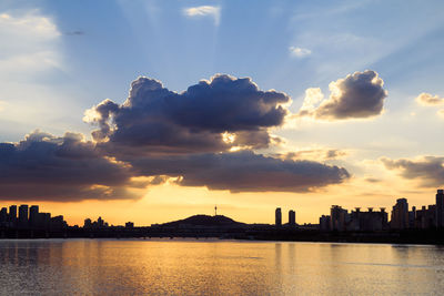 Scenic view of silhouette buildings against sky during sunset