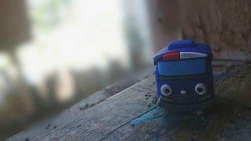 Close-up of toy on table against wall